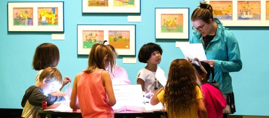 A group of children work on a project in the gallery for Bart at TAM. 