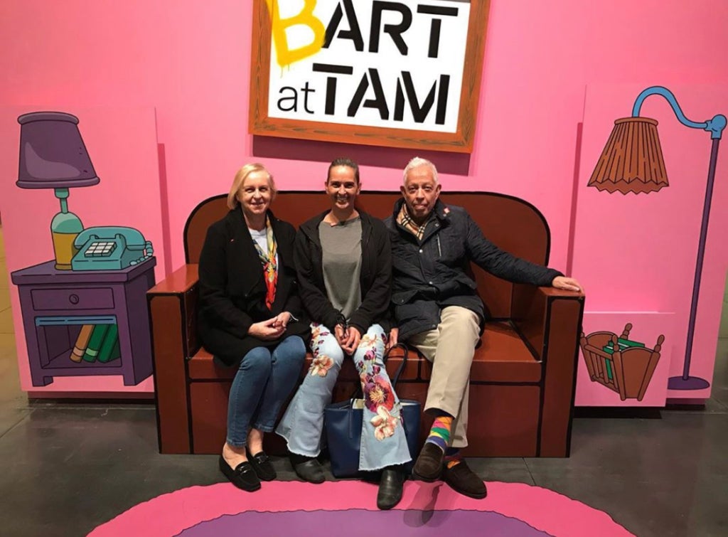 Three people sit on the couch in Bart at TAM: Animating America's Favorite Family. 