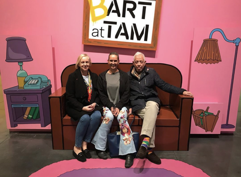 Three people sit on the couch in Bart at TAM: Animating America's Favorite Family.