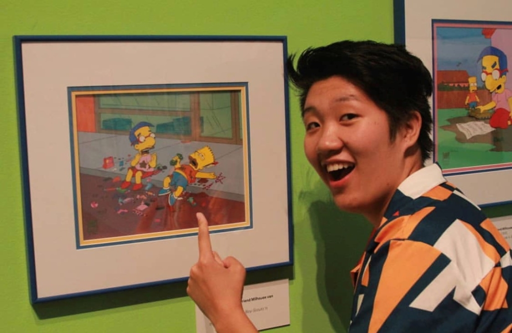 Visitor pointing at animation cel on view in Bart at TAM: Animating America's Favorite Family. 