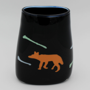 Black basket shaped vessel featuring an image of coyote and coyote bones.