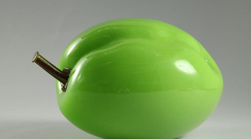 Bulbous, lime-green sculpture of a plum.