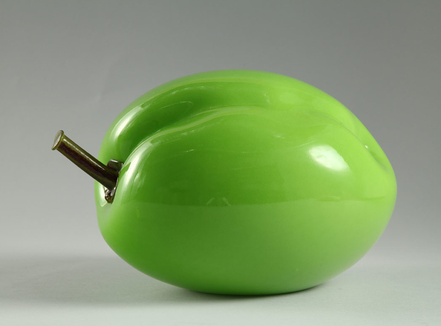 Bulbous, lime-green sculpture of a plum.