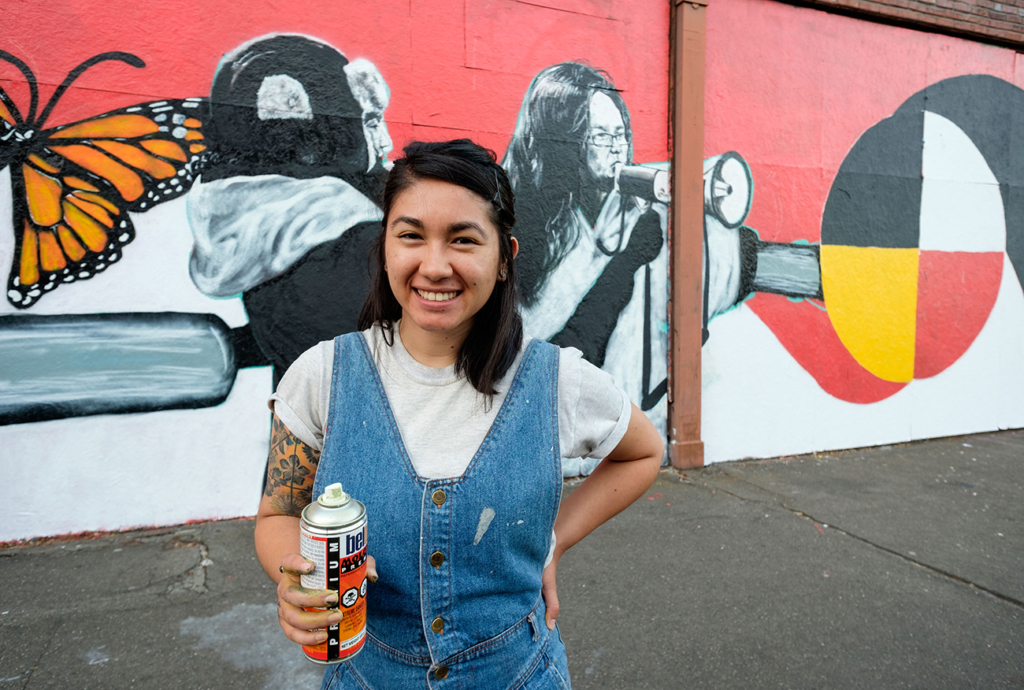 Saiyare Refaei working on a mural for Tacoma Spaceworks on the corner of 11th and Market in downtown Tacoma.