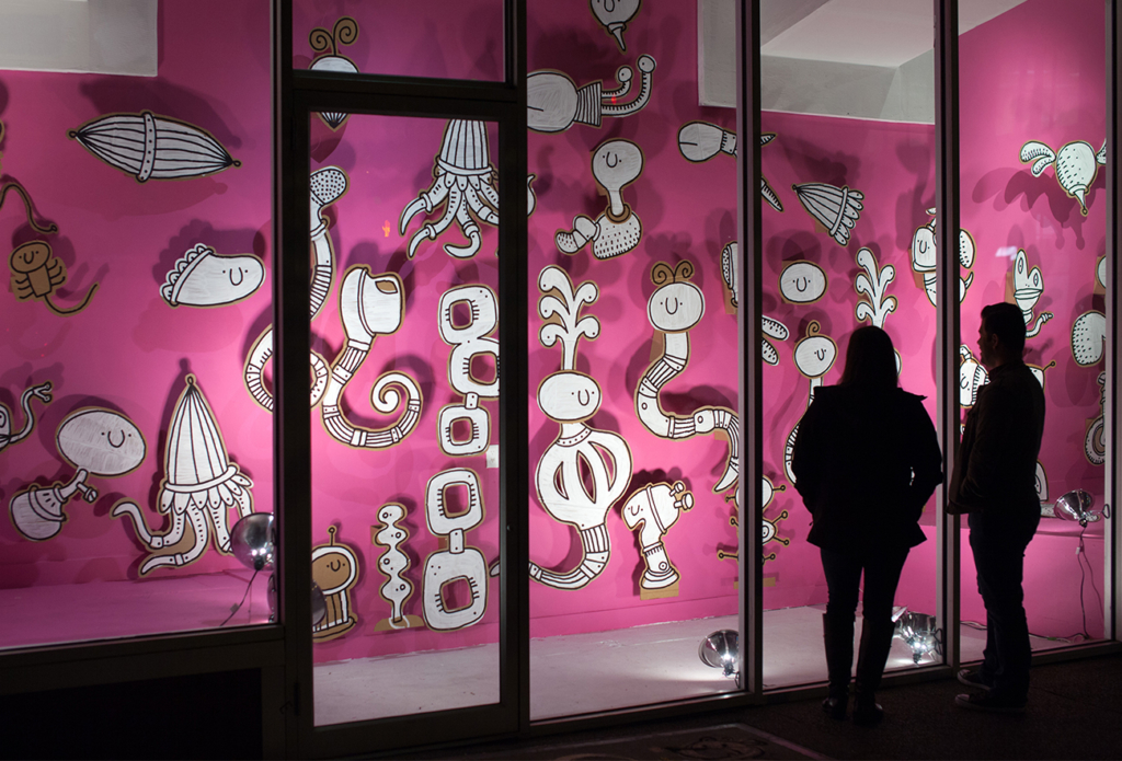 Installation of white sculptural shapes in a storefront window in downtown Tacoma, WA.