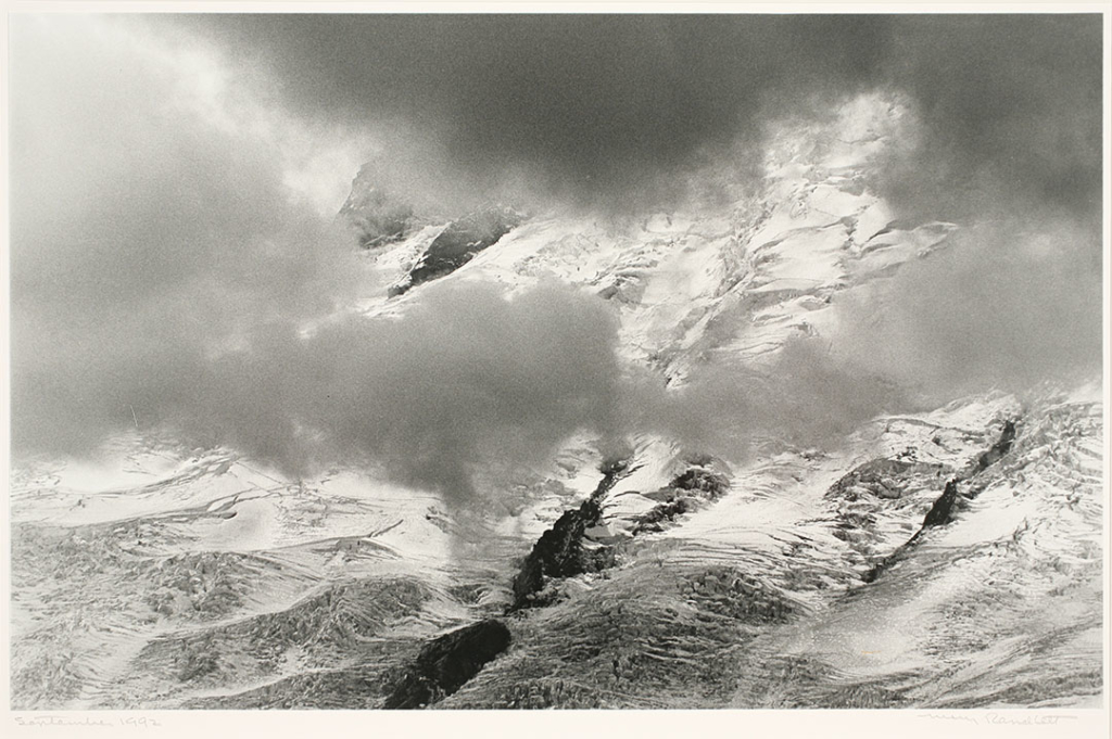 Photograph Credit Line: Museum purchase with funds from Nancy S. Nordhoff in honor of Mary Randlett Object number: 2008.8.20 DescriptionBlack and white photograph of snowy mountains seen through clouds.