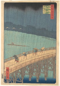 Four men cross a long bridge while rain pours down. 