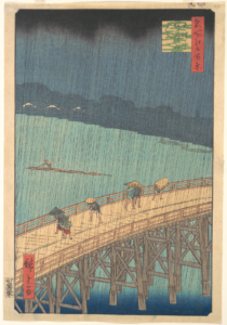 Four men cross a long bridge while rain pours down.