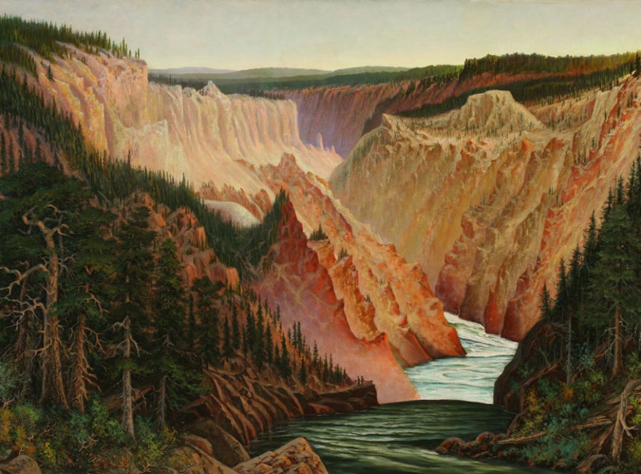 View up the canyon of the Yellowstone River. The river runs from the top center to bottom center of the picture. The steep eroded sides of the canyon frame the river on either side in pink, yellow, and white. On either side of the river in the foreground are patches of forest.