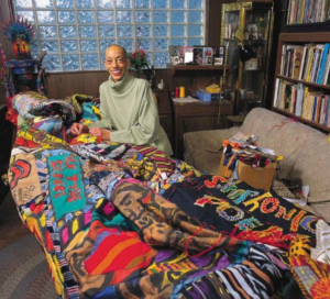 Artist Aminah Robinson pictured in her studio with one of her pieces