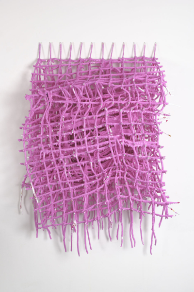 A three-dimensional grid of string covered in pink paint. The weight of the paint has deformed the string grid.