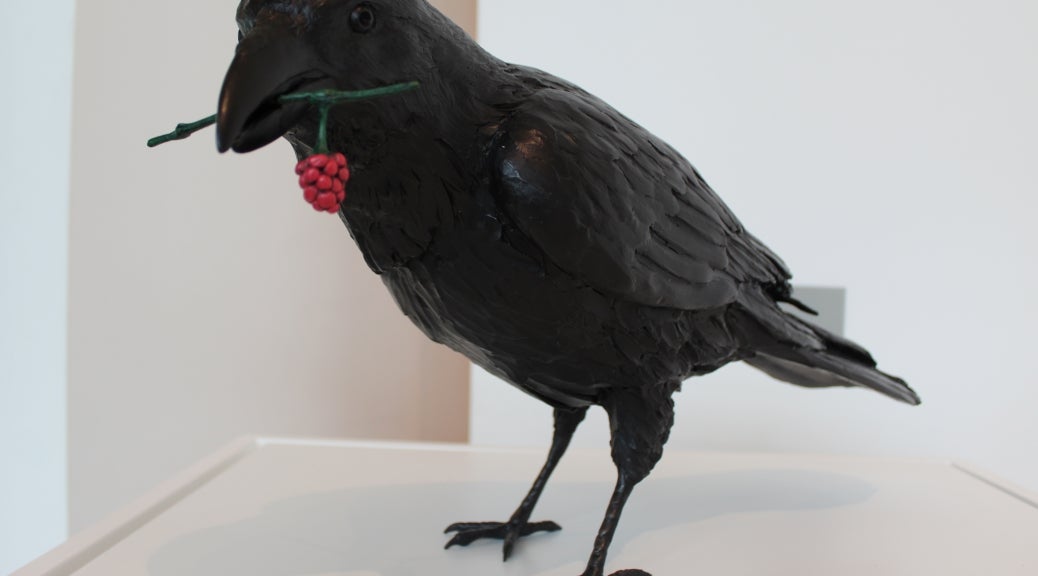 Photograph of Marvin Oliver's brass sculpture "Raven with Salmonberry."