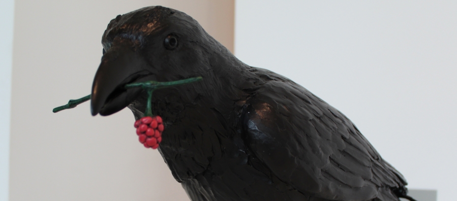 Photograph of Marvin Oliver's brass sculpture "Raven with Salmonberry."