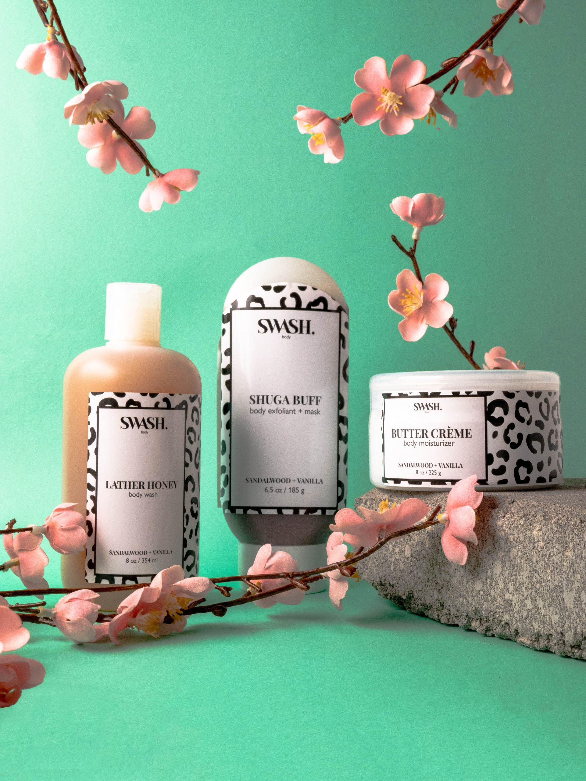Image of SWASH skincare products displayed with cherry blossoms in front of a blue-green background