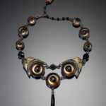 Color photo of "Look Out" necklace by artist Nancy Worden