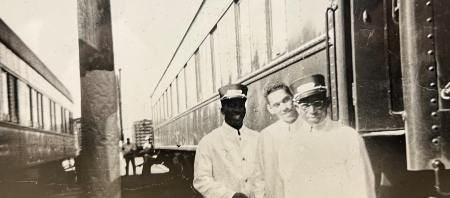 Photo of three Pullman Porters posed in front of a train.