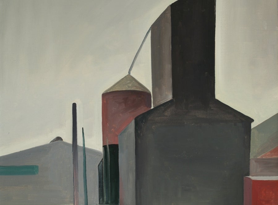 Industrial farm scene with a grain silo and grey hills in the background.