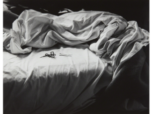 Black and white photograph of an unmade bed by artist Imogen Cunningham