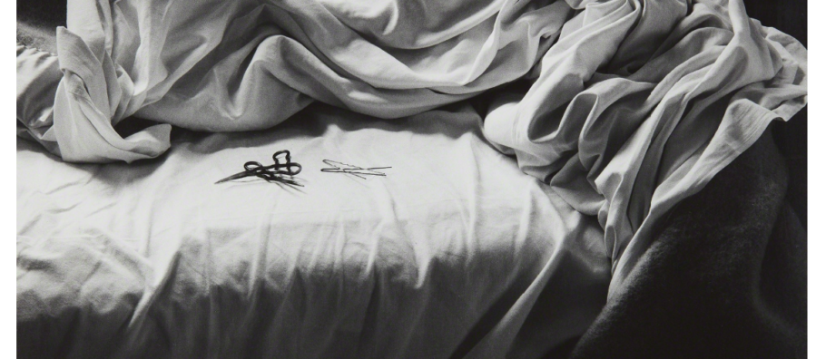 Black and white photograph of an unmade bed by artist Imogen Cunningham