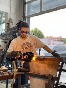 Color photo of glass artist Edgar Valentine in a studio setting.