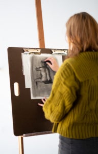 Woman figure drawing at easel