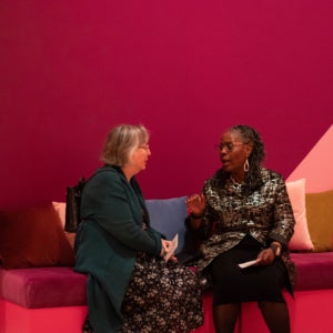 Two women talking on Museum Couch